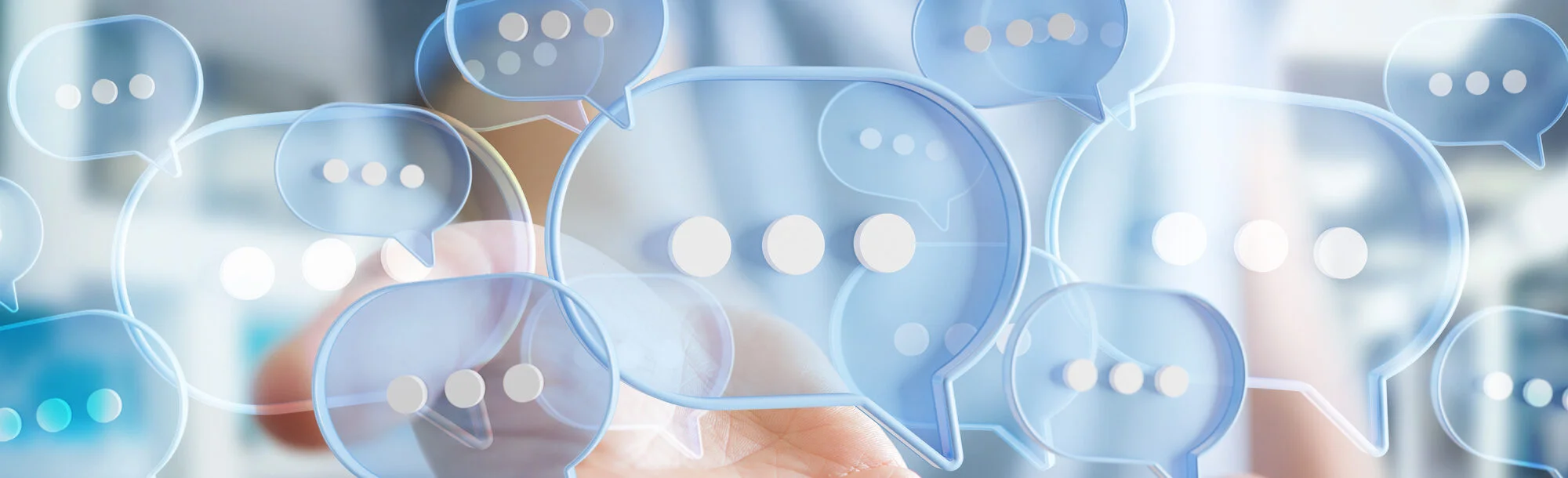 digital blue speech bubbles talk icons floating over user hand