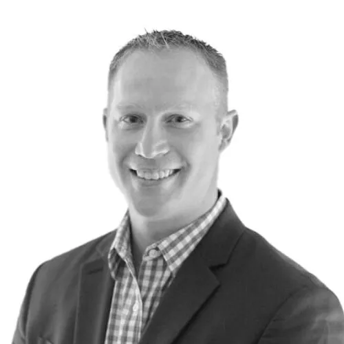 Nick Freeman in suit black and white headshot.